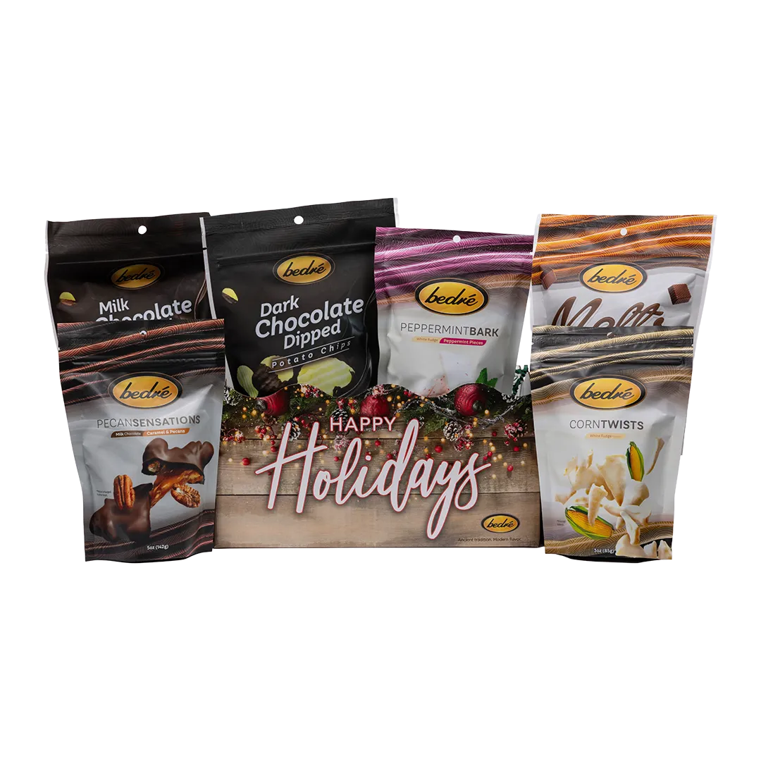 Bedré Fine Chocolate Happy Holidays Garland Gift Box fully styled with Milk and Dark Chocolate Dipped Potato Chips, Melts, Corn Twists, and Pecan Sensations
