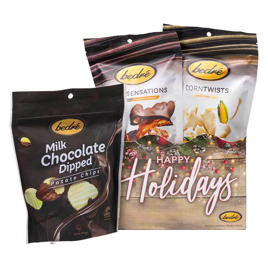 Bedré Fine Chocolate Happy Holidays Garland Gift Box styled with Milk Chocolate Dipped Potato Chips, Pecan Sensations, and Corn Twists
