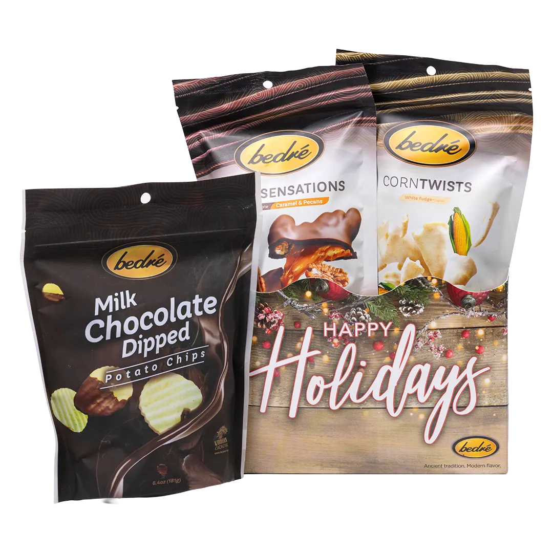 Bedré Fine Chocolate Happy Holidays Garland Gift Box styled with Milk Chocolate Dipped Potato Chips, Pecan Sensations, and Corn Twists