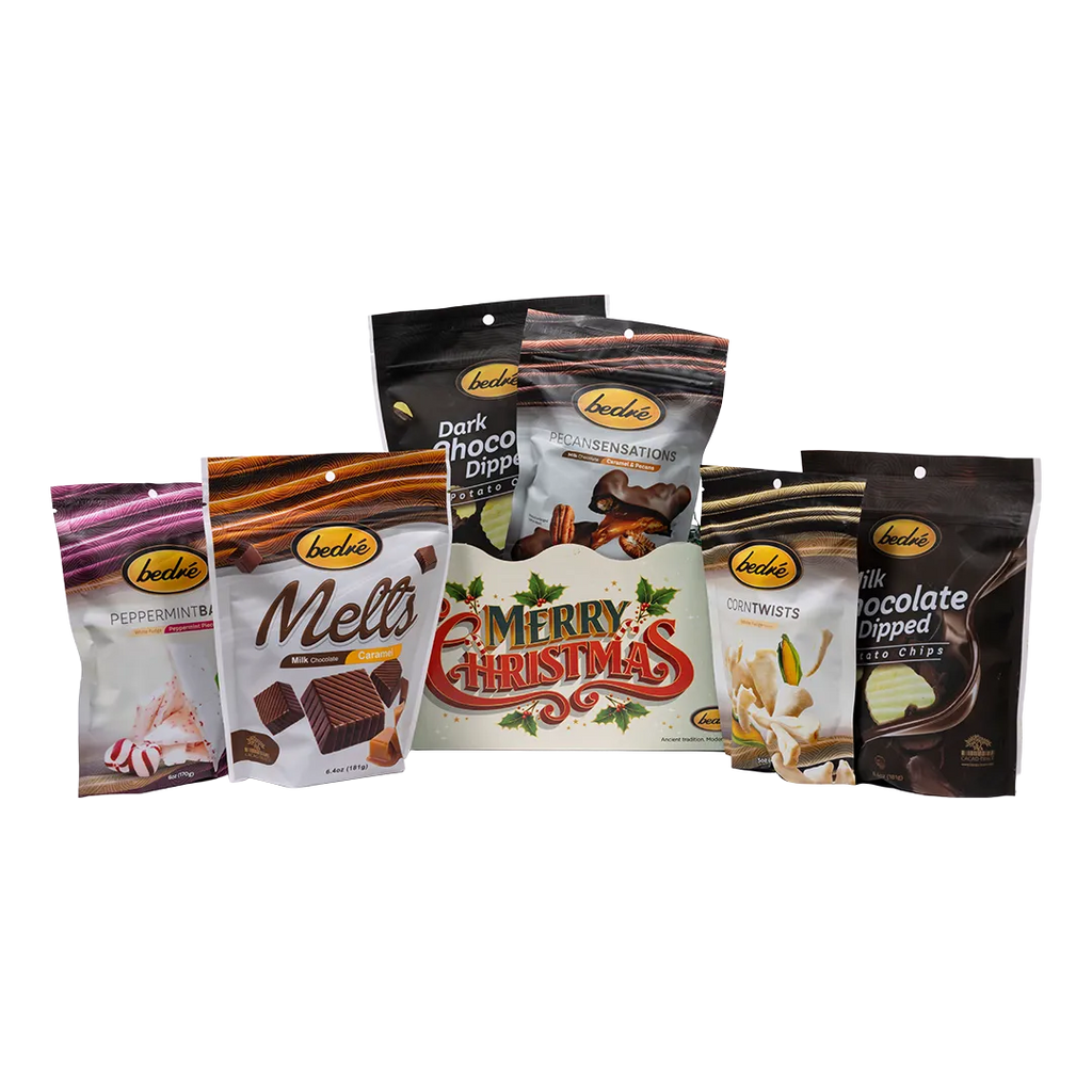 Bedre light-green retro Merry Christmas gift box with Pecan Sensations, Peppermint Bark, and Corn Twists pouches nestled behind it, and a black pouch partially visible behind them