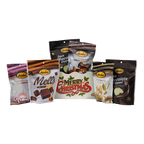 Bedre light-green retro Merry Christmas gift box with Pecan Sensations, Peppermint Bark, and Corn Twists pouches nestled behind it, and a black pouch partially visible behind them