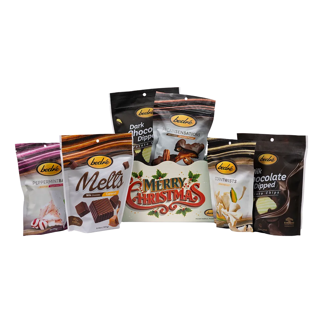 Bedre light-green retro Merry Christmas gift box with Pecan Sensations, Peppermint Bark, and Corn Twists pouches nestled behind it, and a black pouch partially visible behind them