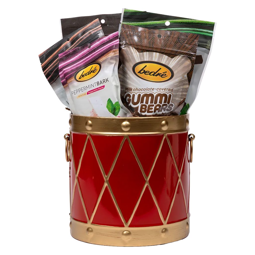 Bedré Fine Chocolate red and gold Christmas Drum tin (medium), filled with Pecan Sensations, Pistachio Cranberry Bark, and Milk Chocolate Dipped Potato Chips pouches