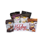 Happy Holidays snow-themed gift box with Bedré Pecan Sensations, Peppermint Bark, and Corn Twists pouches standing behind it, full white background margin on all sides