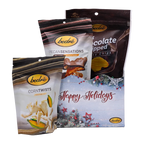 Bedré Fine Chocolate Happy Holidays Tinsel Star Gift Box styled with Milk Chocolate Dipped Potato Chips, Pecan Sensations, and Corn Twists