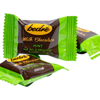 Individually wrapped Bedré Milk Chocolate Mint Melts pieces in green foil