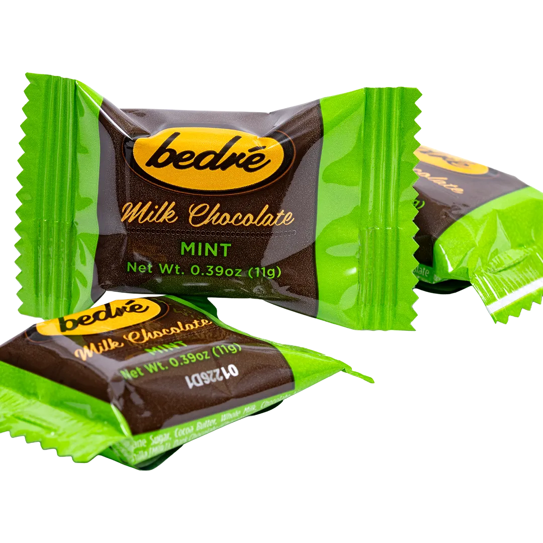 Individually wrapped Bedré Milk Chocolate Mint Melts pieces in green foil