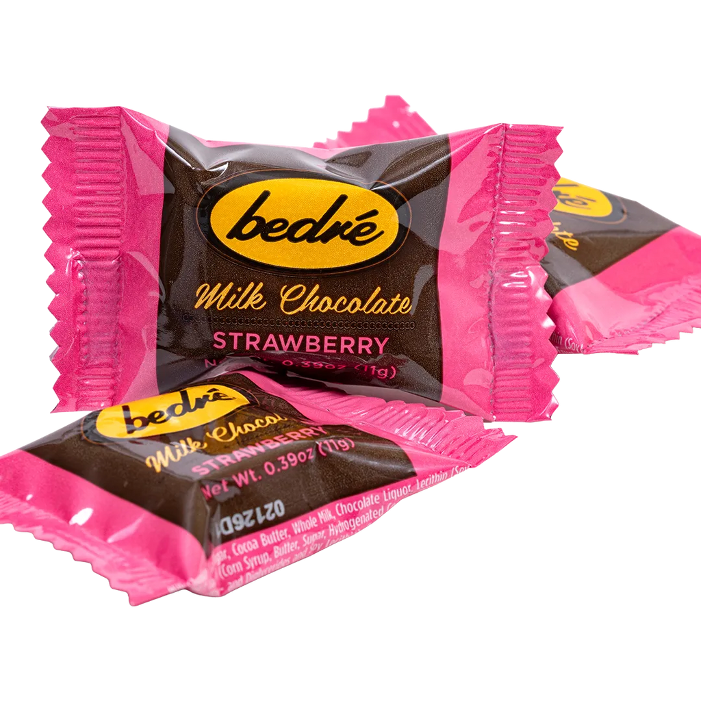 Individually wrapped Bedré Milk Chocolate Strawberry Melts pieces in pink foil