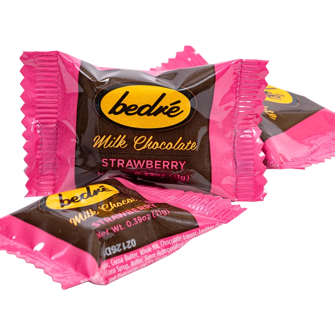 Individually wrapped Bedré Milk Chocolate Strawberry Melts pieces in pink foil