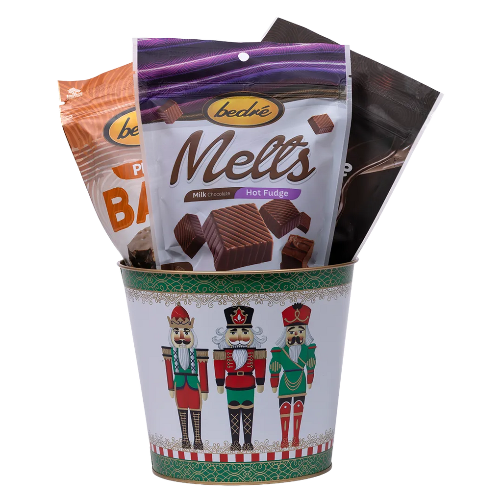 Bedré Fine Chocolate Nutcracker Three tin (medium) illustrated with three nutcracker soldiers, filled with Melts Hot Fudge and Pecan Bark pouches